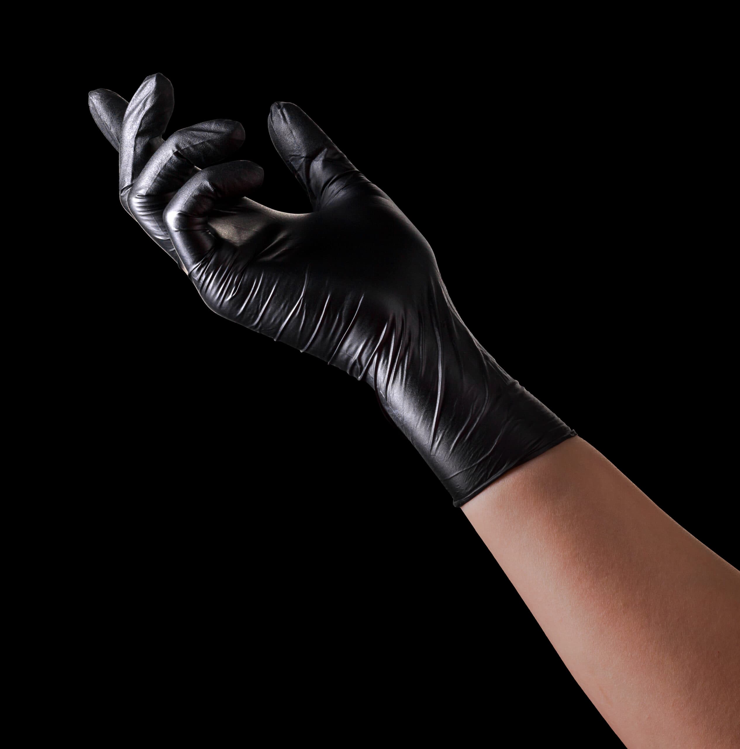 Hand,In,Black,Glove,Holding,Something,On,Black,Background.,Isolated
